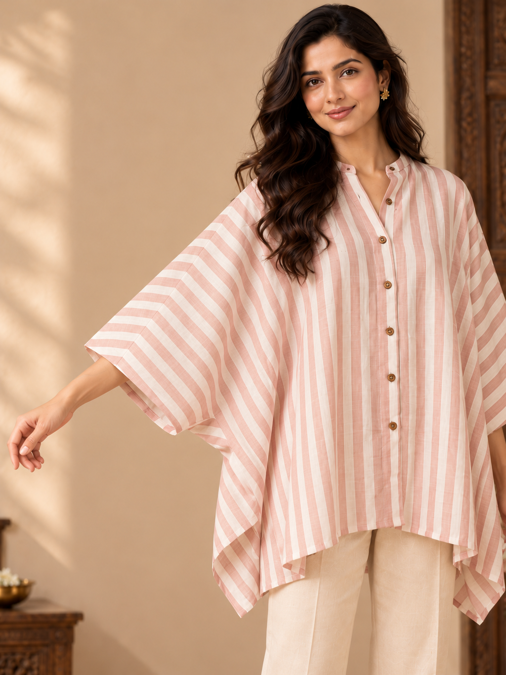 Pink and ivory striped cotton kaftan top for women with a button-down front, wide sleeves and an asymmetrical hem.