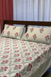 White cotton bedsheet with red floral handblock prints and matching pillow covers. Breathable, handcrafted bedding designed for elegant everyday comfort.