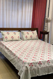 White cotton bedsheet with red floral handblock prints and matching pillow covers. Breathable, handcrafted bedding designed for elegant everyday comfort.